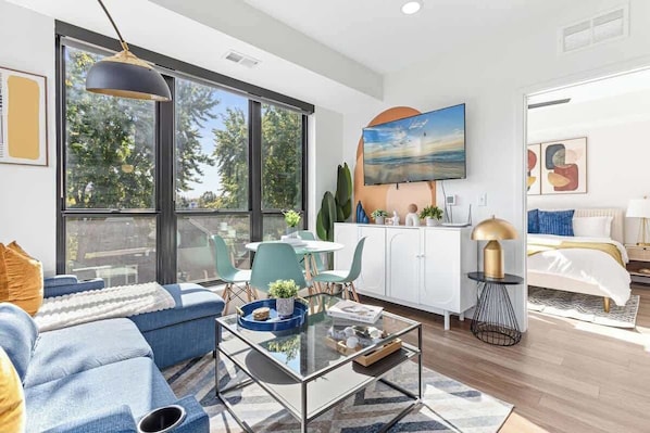 Bright, modern oasis with chic decor, smart TV, and cozy bedroom for ultimate comfort.
