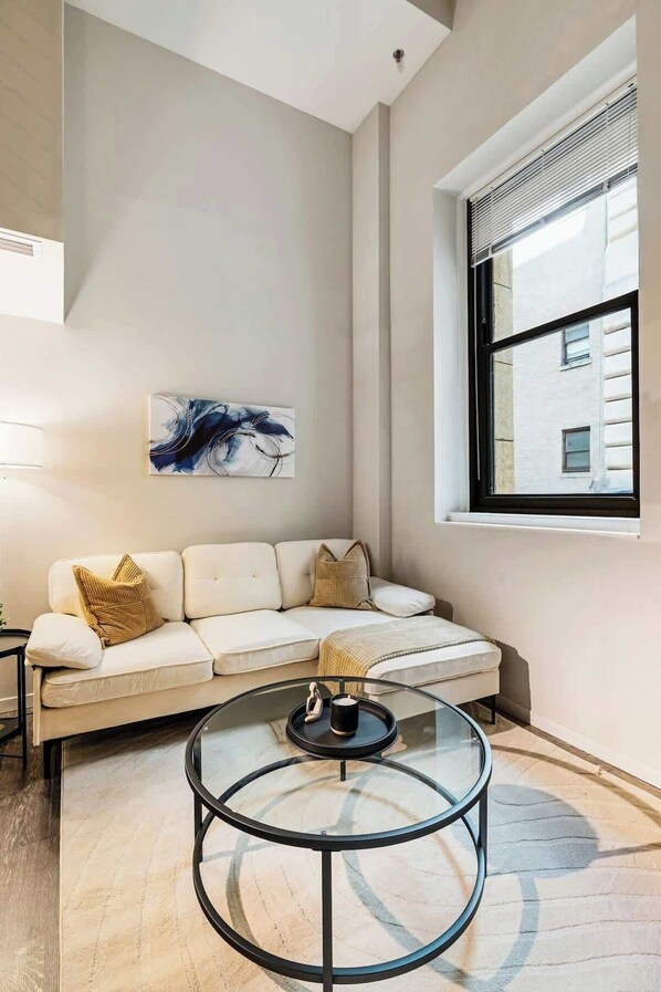 Modern loft with high ceilings, cozy seating, and chic decor in the heart of the city.