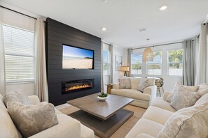 Cozy living room with plush seating and vibrant coastal decor.
