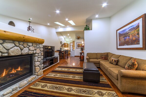 Gorgeous open living area with warm hardwood flooring throughout