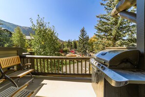 Private deck off living room with seating area and private BBQ, stocked with free propane.