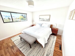 King bedroom features stunning Mountain View, low dresser to place luggage on.