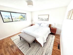 King bedroom features stunning Mountain View, low dresser to place luggage on.