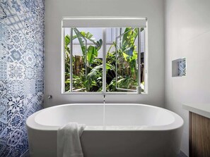 Main bathroom (ground floor) with bath, shower, vanity and separate WC.