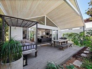 Deck at rear with daybed, outdoor dining and BBQ