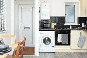 Fully equipped kitchen with washing machine perfect for long term stays