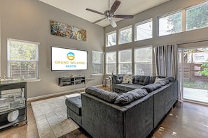 Bright living space with sectional sofa, TV, and queen sofa sleeper