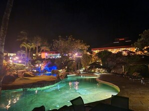 Night view of pool and Happy Talk Lounge and Wiki Pizza. 