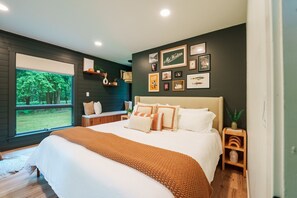 the master bedroom with a king bed, private reading nook, and views of finch creek.