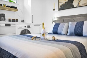 "Elegant bedroom with soft lighting, abstract art, and a cozy ambiance."