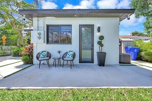 Cozy patio with stylish seating, ideal for a relaxing outdoor retreat.