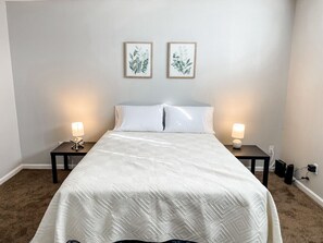 Rest easy on this comfortable queen bed, your cozy retreat for a good night’s sleep