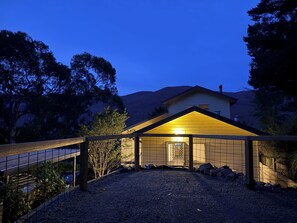 Night time view from raised patio rear of house.