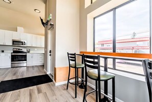 Step into our inviting shared kitchen, packed with a stylish bar & comfy stools.