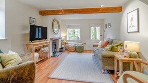 Exposed beams and wooden floors add warmth
