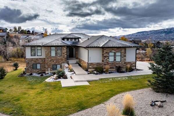 Modern Powder Mountain is a stunning new home set on a spacious lot with lush green lawn and breathtaking mountain views