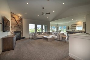 The living room has a large smart TV, amaxing views, and direct access to the balcony.