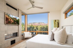 Primary Bedroom includes views of Thunder Mountain, King sized bed, fireplace, Smart TV, and ensuite bathroom.