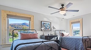 Bright and cozy bedroom with twin beds and beautiful mountain views.