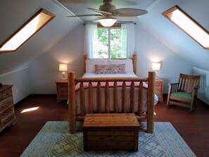 Luxurious full log bed with rocking chair.