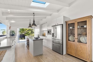 Fully equipped kitchen with bi-fold doors and windows for great flow to outdoors