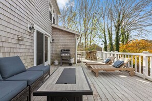 Spacious deck with sectional, fire table, lounge chairs dining table & grill. 