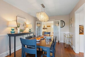 Dining room located between the living room and kitchen with sliders to the deck