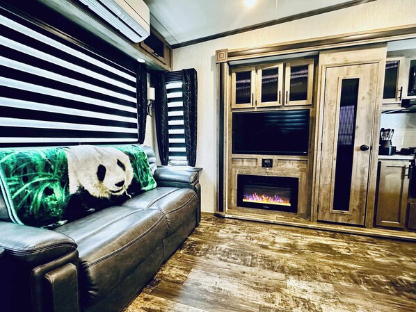 Cozy living area with fireplace and smart TV