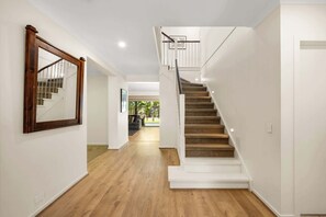 Beautiful staircase and high ceilings leading into the property
