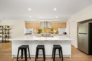 Expansive kitchen with modern appliances and breakfast bar