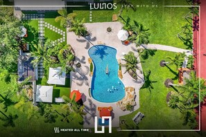 Luxurious villa with a stunning pool, lush gardens, and relaxing outdoor spaces.