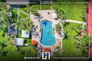 Luxurious villa with a stunning pool, lush gardens, and relaxing outdoor spaces.