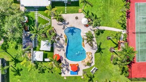 Luxurious villa with a stunning pool, lush gardens, and relaxing outdoor spaces.