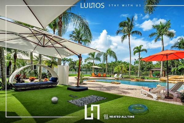 Unwind in style – shaded loungers, lush surroundings, and total relaxation await