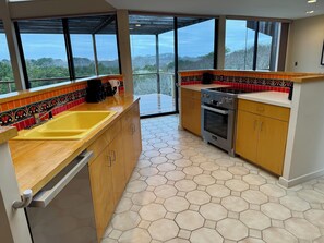 Our home’s open concept layout features a central kitchen with new appliances…