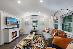 colorful living room brings cozy vibes with a fireplace