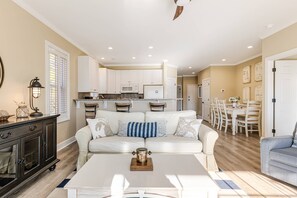 Spacious living area featuring a cozy sofa and a stylish center table,