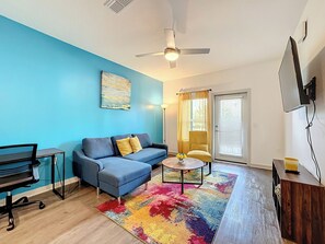 Relax and unwind in this stylish and cozy living room with 50 inch TV and futon.