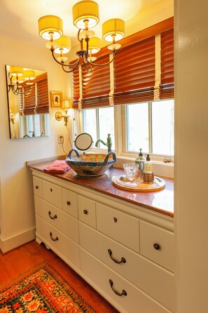 Farm windows sit atop the copper counter and Mexican pottery vessel sink
