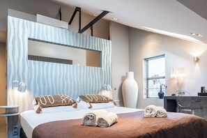 A beautifully designed bedroom with a large, inviting bed, soft lighting, and modern decor, offering a relaxing and stylish retreat.
