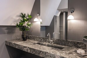 The bathroom is fully furnished, featuring a spacious layout and a large mirror.