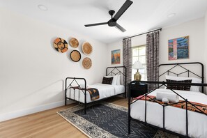 Double the comfort, double the style! 🛏️✨ Who needs just one bed when you can have two twin beds for twice the dreams? Add in a breezy ceiling fan and a chic armoire, and you've got the perfect hangout spot! 
