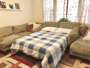 The couch in the living room can be converted to a queen size bed