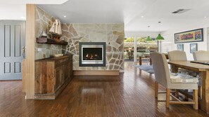 Open plan living dining area with fire. 