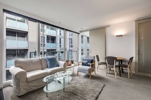 A sofa and armchair in the living area offer a relaxed setting to unwind with some TV, while portable fans and radiator wall heating help to keep you comfortable year-round.