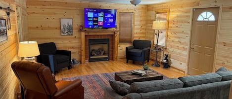 Living room with fireplace and pullout sofa with memory foam mattress.