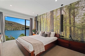 The master bedroom is large, very stylish, and oh so comfortable!

Just imagine laying in bed, staring at that world class view of the Remarkables Mountains and Lake Wakatipu!
