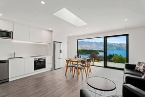 Enjoy fantastic views of the Remarkables Mountains and Lake Wakatipu from the spacious open plan kitchen, living room and dining room.

There is no external balcony.  You can open the  sliding doors up wide.  A glass panel stops you stepping out.