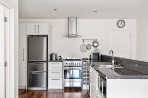 Well equipped kitchen with modern appliances and gas cooking.