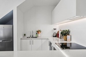 Modern, clean and fresh kitchen featuring all new appliances.